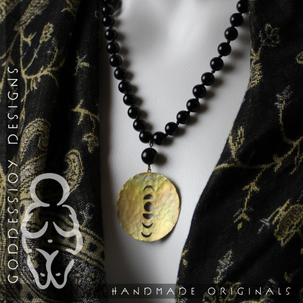 New Moon Necklace - 1.5" Round Brass Moon Phase pendant hanging from a knotted strand of 8mm black obsidian beads